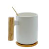 White ceramic mug with bamboo lid and stirrer.