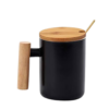 Black ceramic mug with bamboo lid and stirrer.