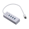 A photo of white USB hub with four ports.