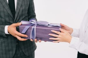 giving-gift-with-violet-gift-wrapper-and-ribbon