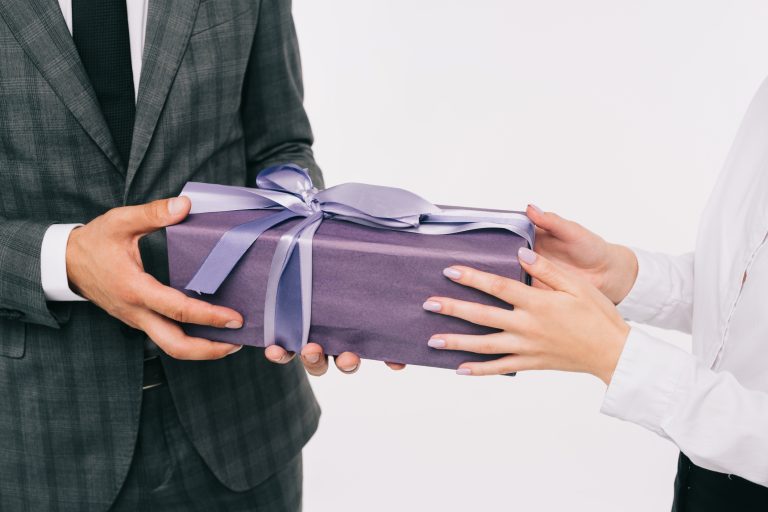giving-gift-with-violet-gift-wrapper-and-ribbon