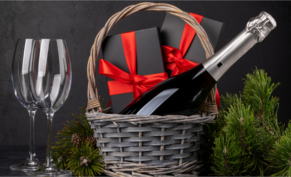 a-wine-glass-and-gift-boxes-with-a-wine-bottle-in-a-basket