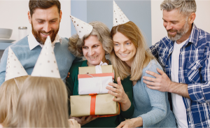 a-group-of-people-wearing-party-hats-and-holding-gifts