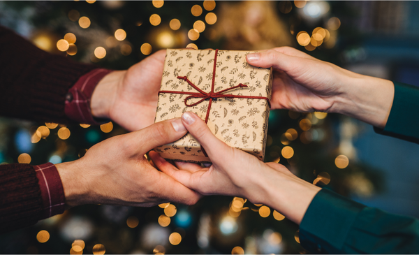 two-hands-holding-a-christmas-gift