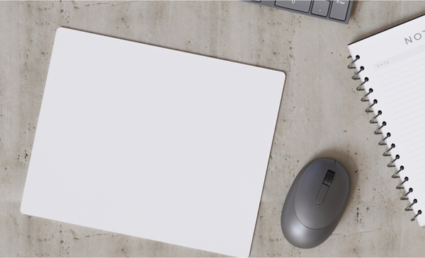 a-white-mouse-pad-with-mouse-and-notebook