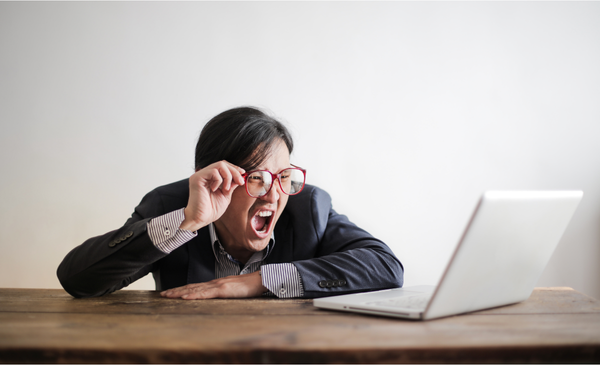 a-frustrated-man-looking-at-his-laptop