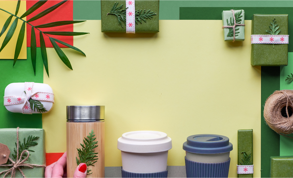Bamboo-flask-coffee-cups-and-boxes-encircling-a-yellow-paper