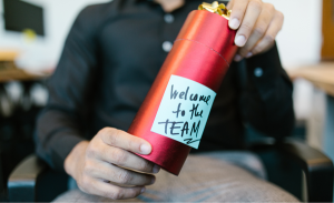 a-red-cylinder-with-a-written-note-welcome-to-the-team
