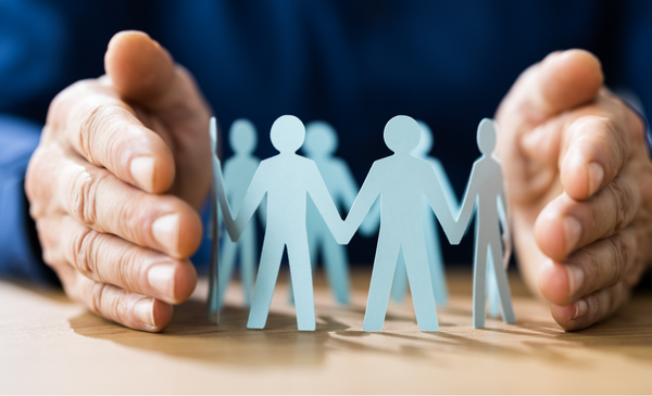 a-hand-with-paper-human-cut-outs